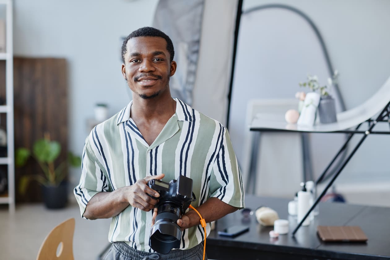 Photographer holding a camera in his studio